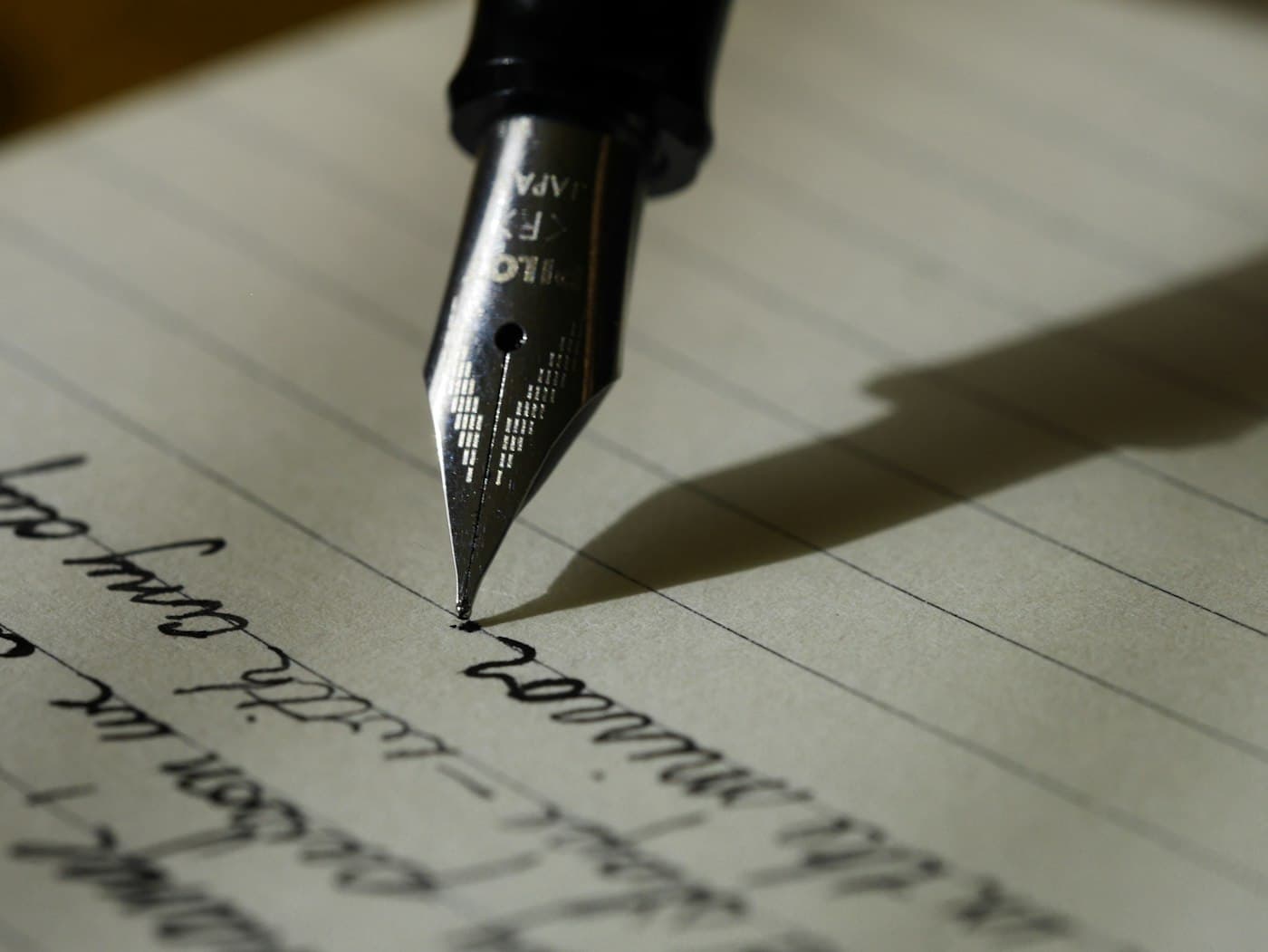 pen writing sentences on paper