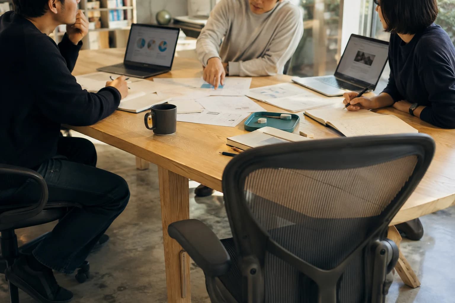 A team reviewing project materials together at a table.
